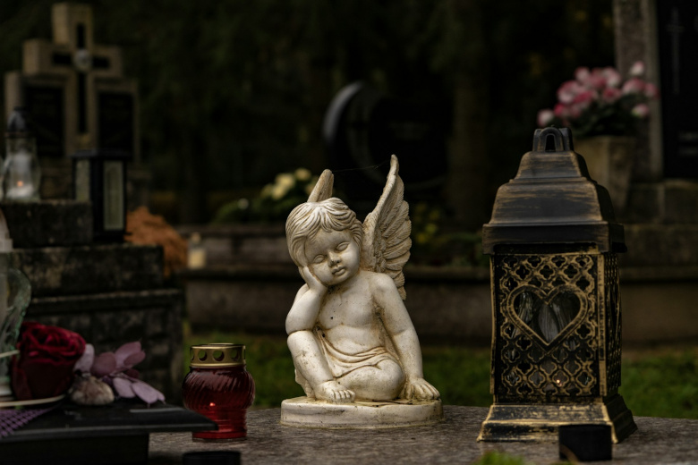 diverse Arten von kleinem Grabschmuck für Urnengräber: Engel, Lichter, Rose
